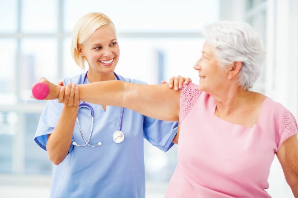 A senior woman and her doctor work on occupational therapy for seniors.