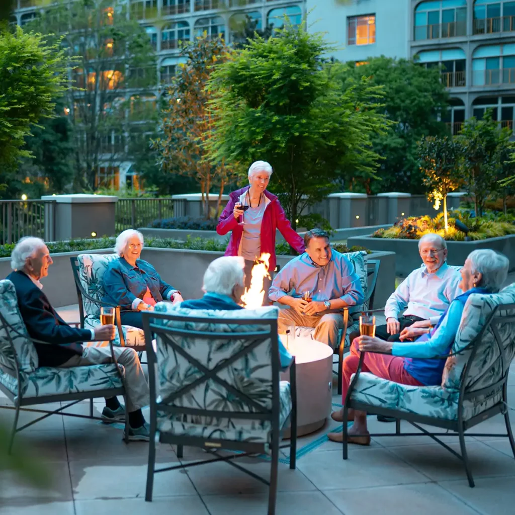 Canterbury residents enjoying time on the Activities deck by the fire pit