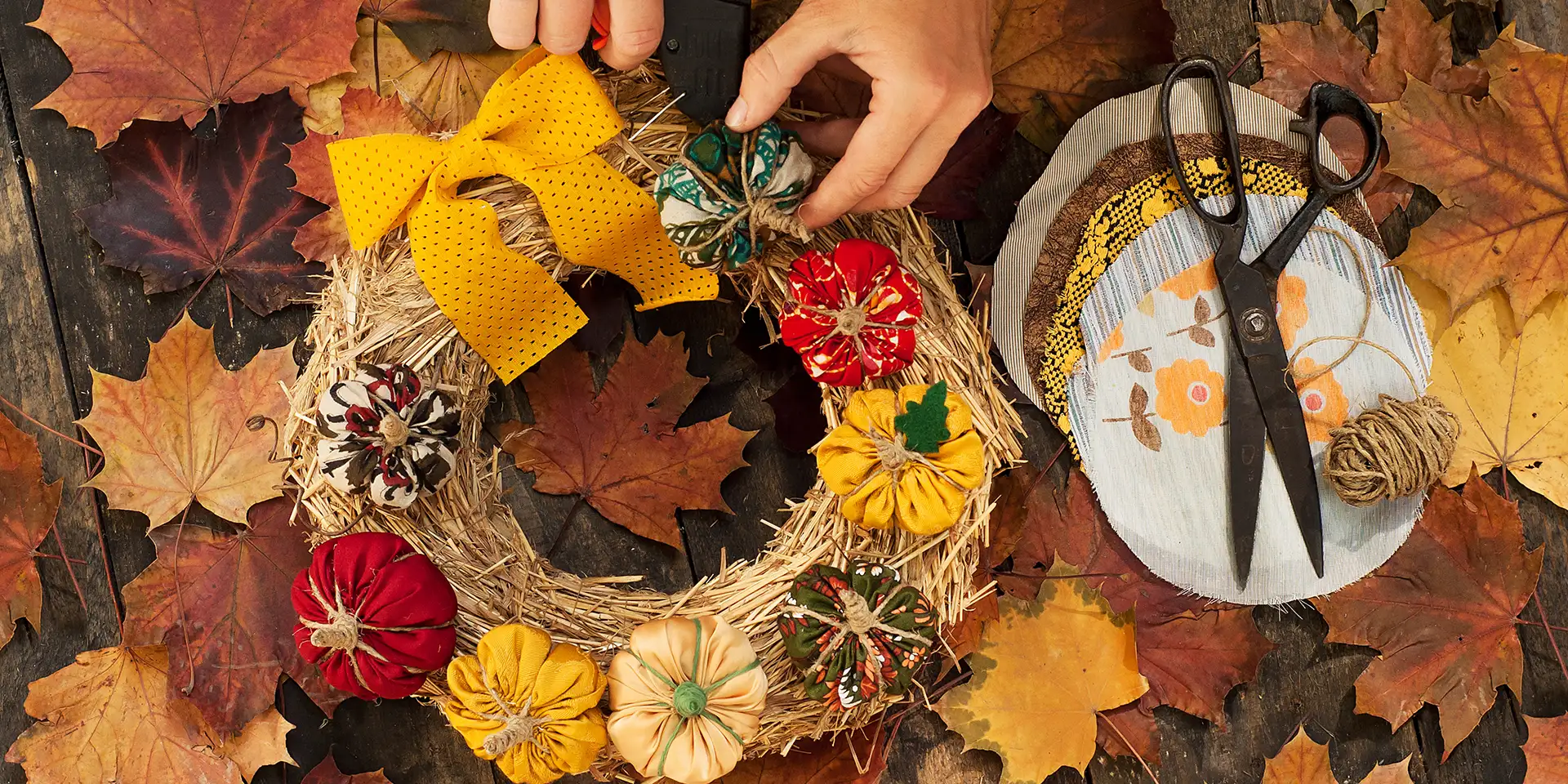 Crafting a fall wreath with leaves and pumpkins