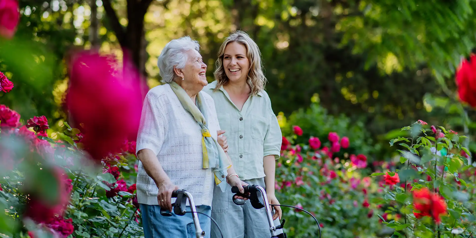 Senior woman and caregiver enjoying a walk outside