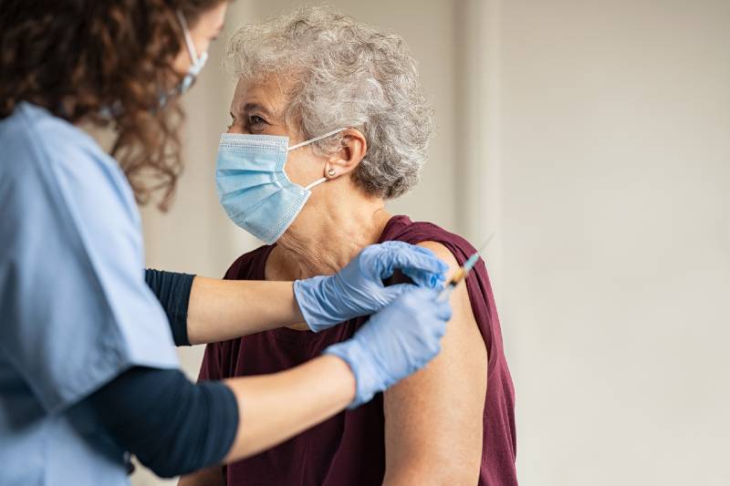 Senior woman receiving her COVID-19 vaccine