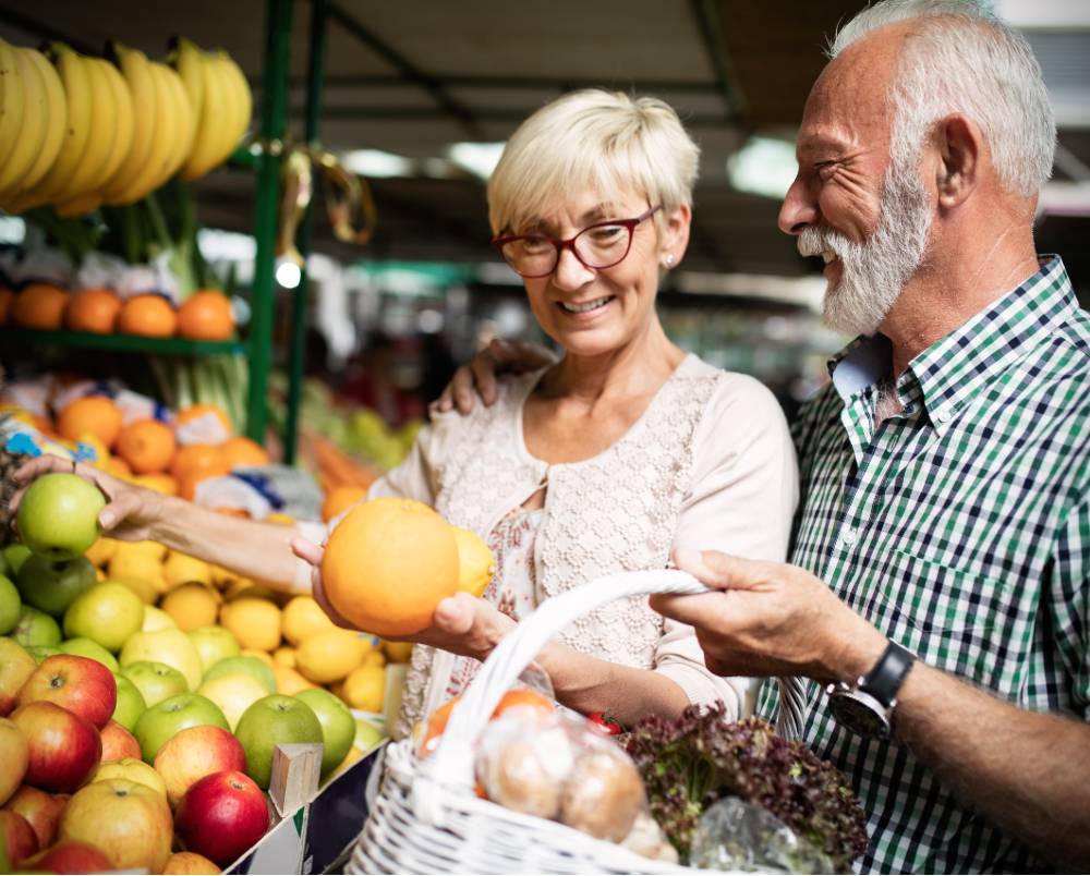 Senior couple shopping for produce