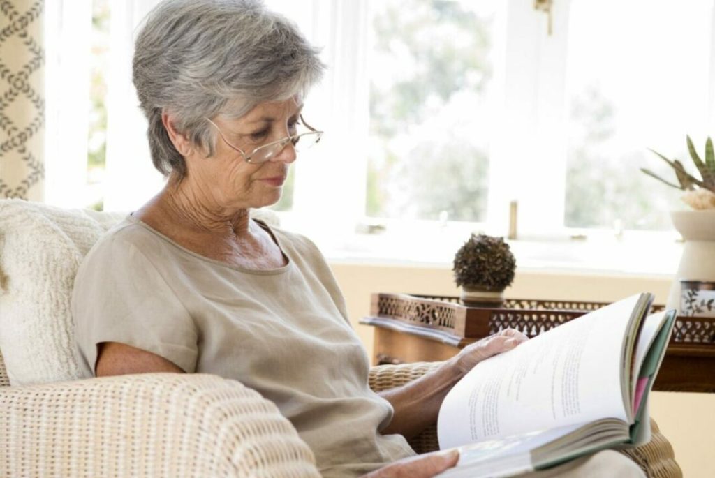 A senior woman reading and putting lifelong learning to use.