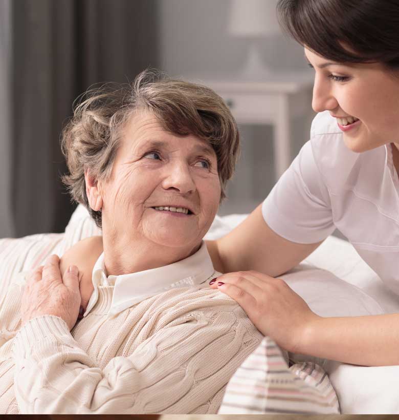 Caregiver helping senior living resident at health services center