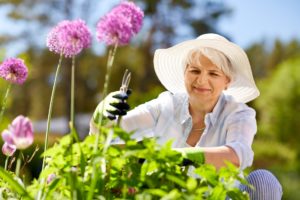 Happy senior woman taking care of her garden