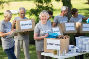 A group of seniors accept donations while volunteering